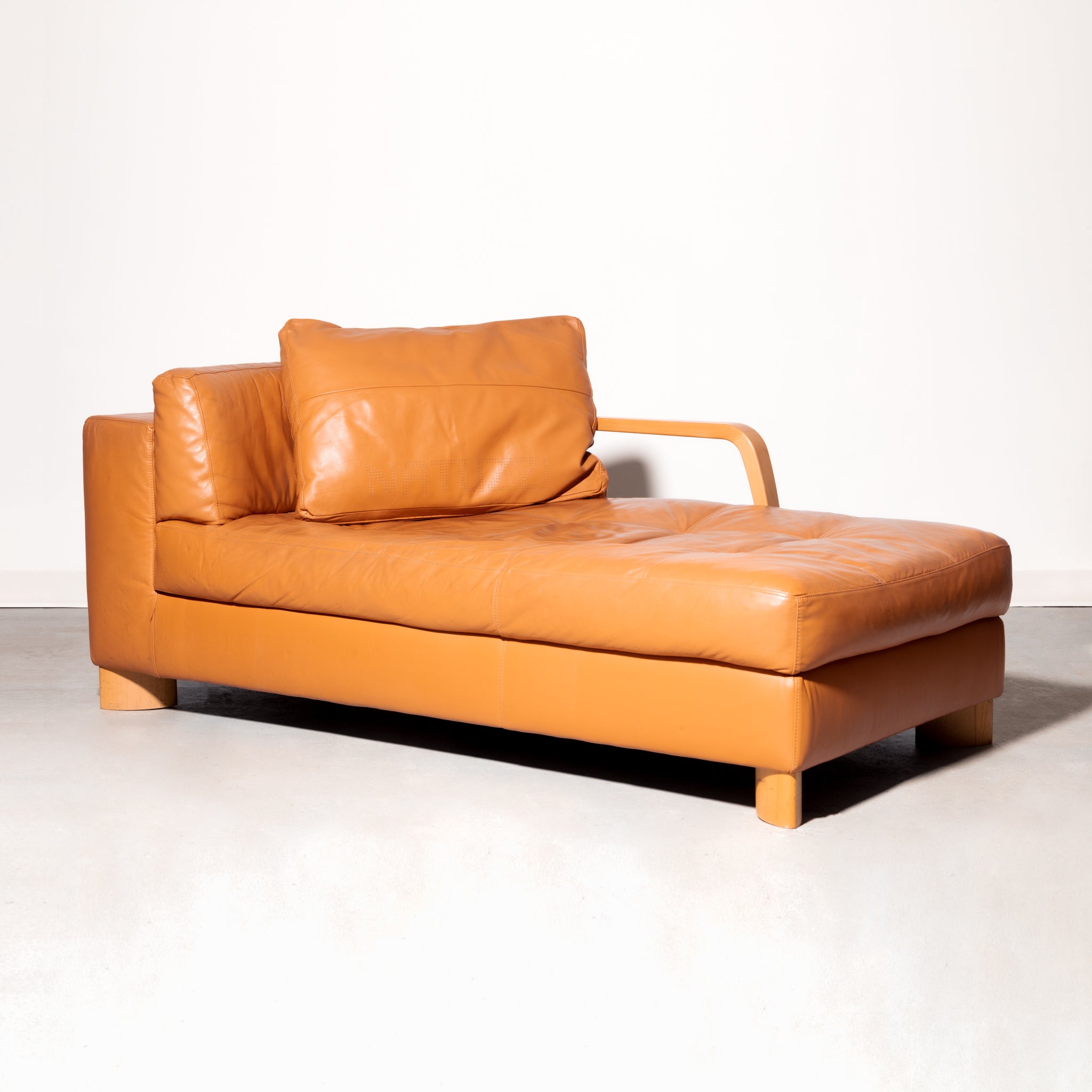 Natuzzi Italian Leather Chaise with perforated logo on the pillow