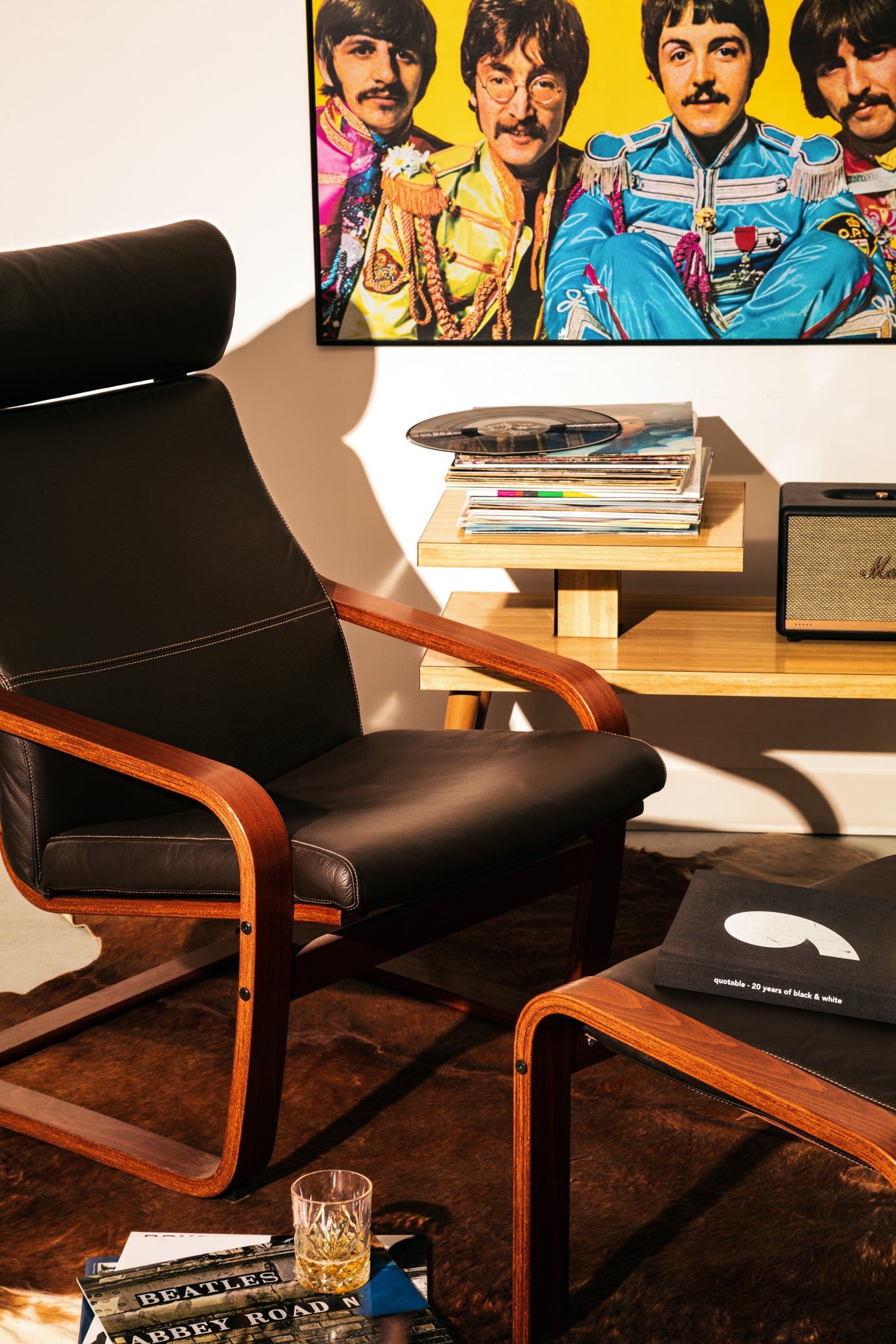 Vintage mid-century modern step end table, designed with smooth wood grain and splayed, tapered legs with brass end caps