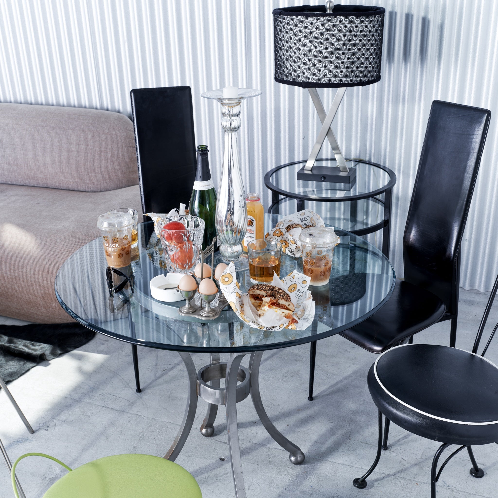 Glass table with drinks and snacks in a modern living room setting