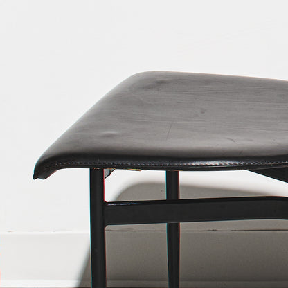 Black leather bench with metal frame on a white background
