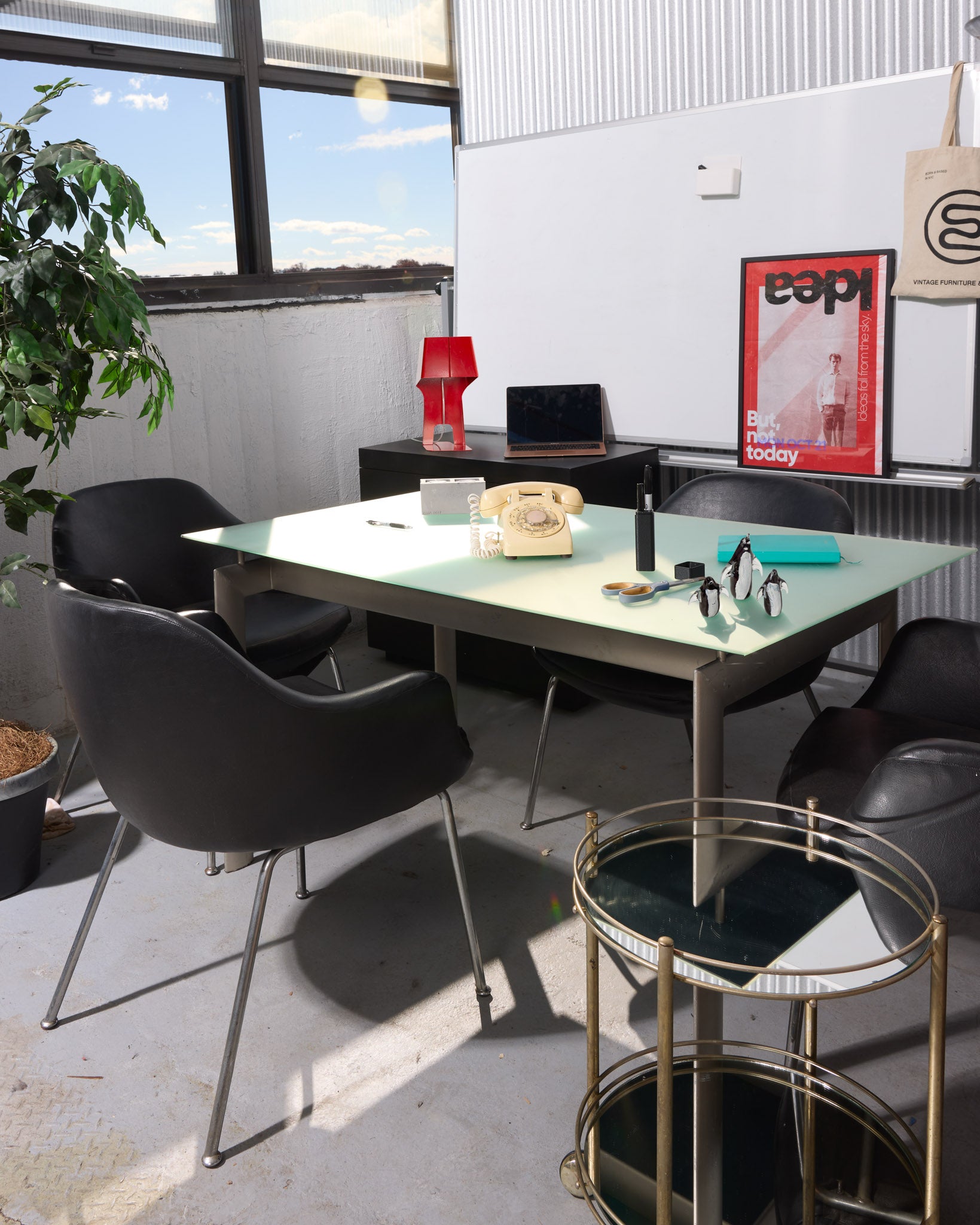 Modern office space with a table, chairs, and decor elements.