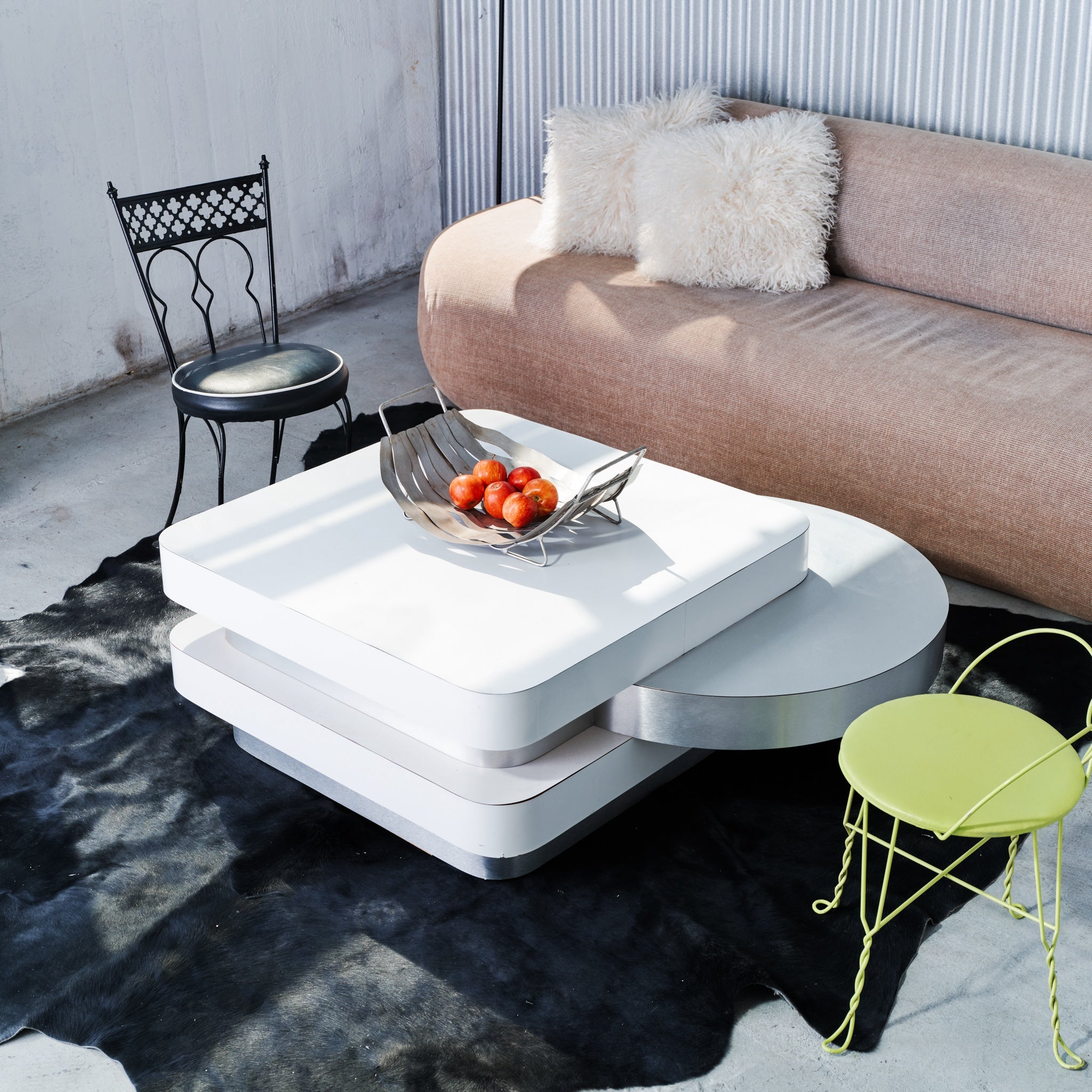 Modern living room with a white coffee table, sofa, and decorative chairs.