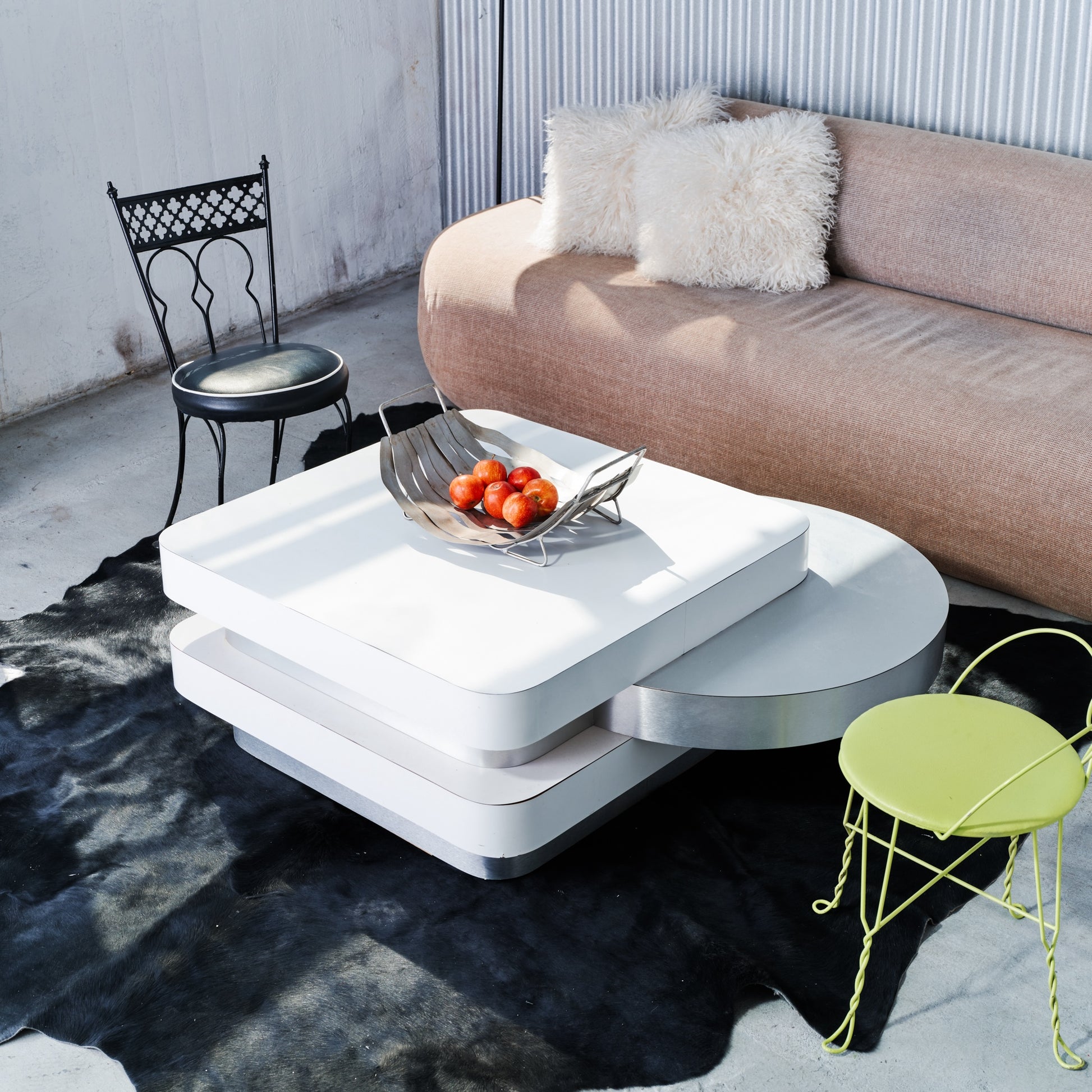 Modern living room with a white coffee table, sofa, and decorative chairs.