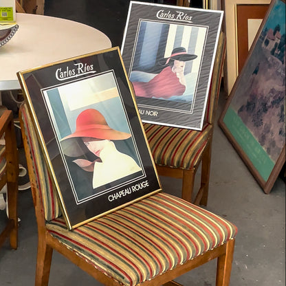 Framed artwork by Carlos Rios on a striped chair