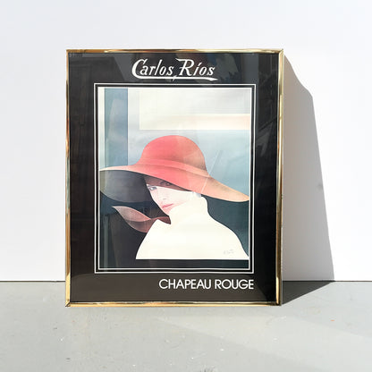 Framed artwork titled 'Chapeau Rouge' by Carlos Rios on a white background