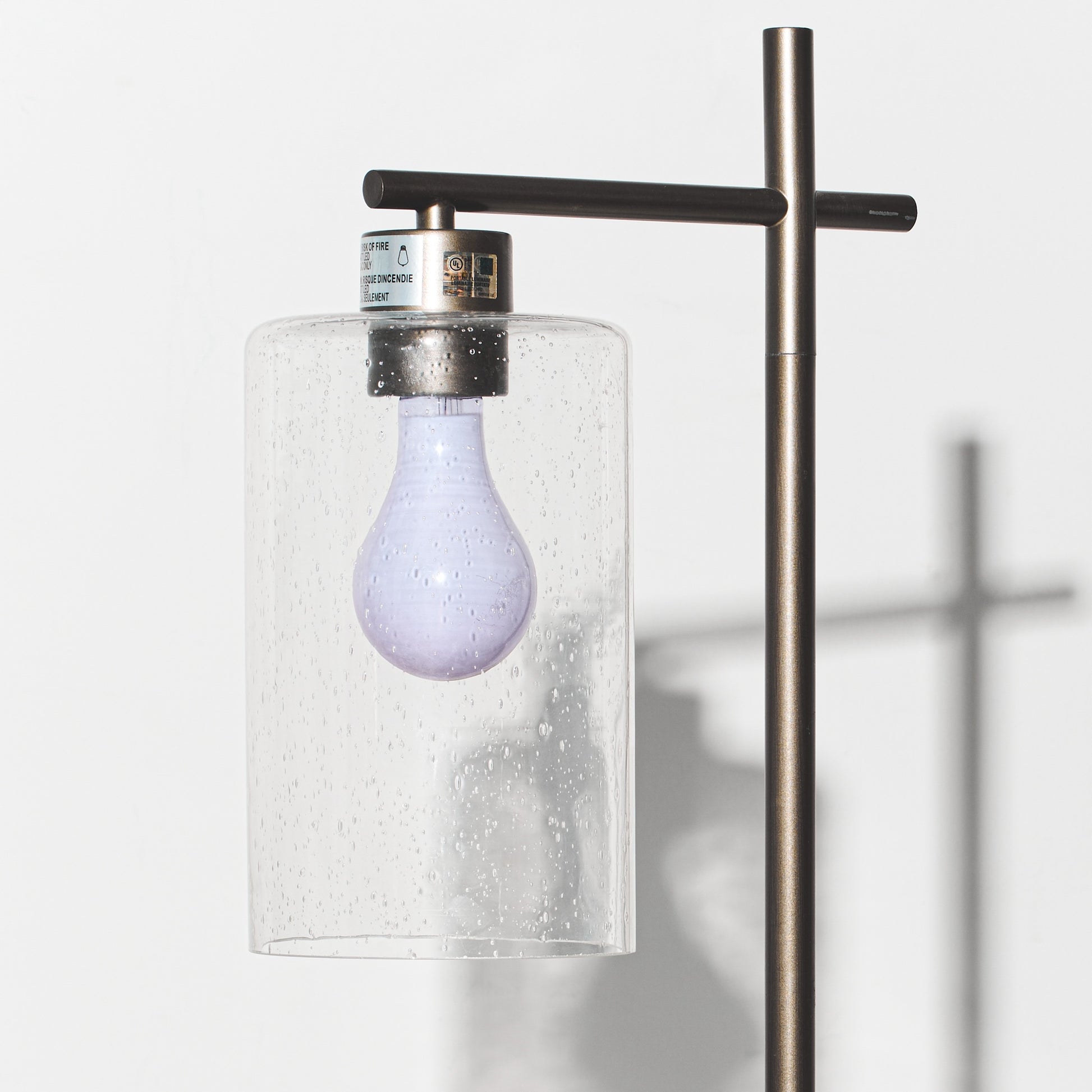 Light bulb in a glass container on a white background