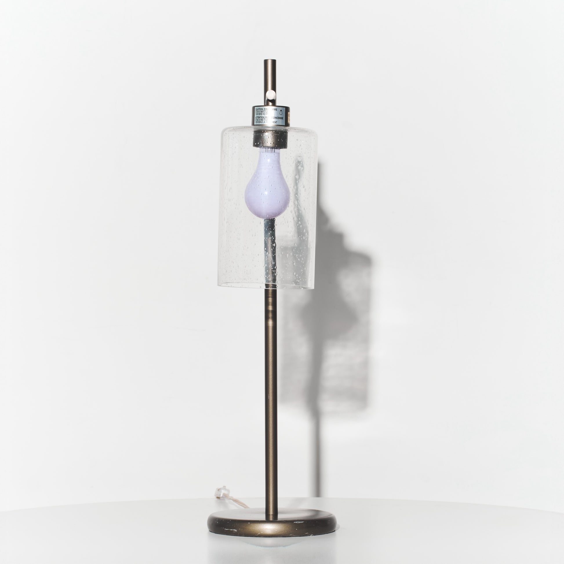 Decorative lamp with a purple bulb on a white background