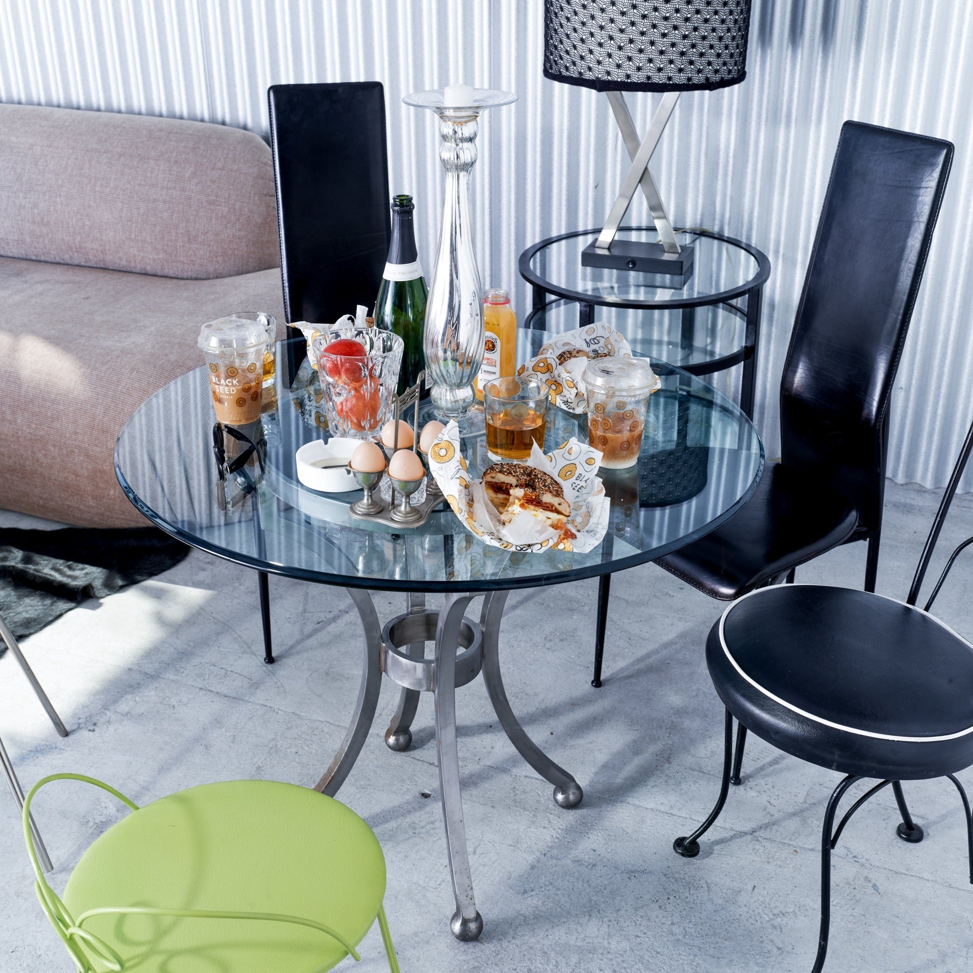 Glass table with drinks and snacks in a modern living room setting