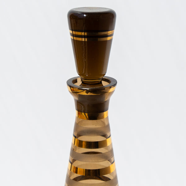 Decorative bottle stopper with striped design on a white background