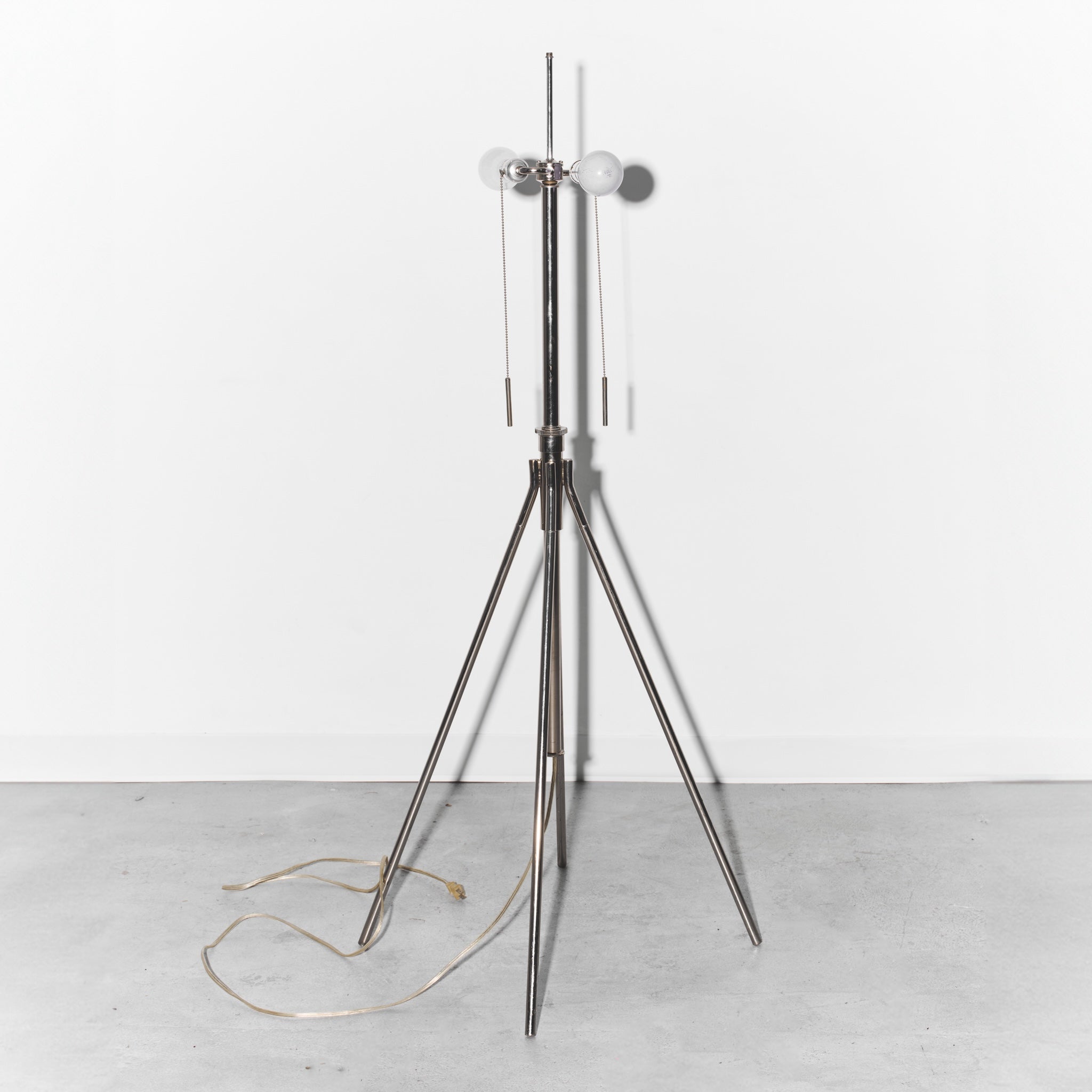 Modern floor lamp with a tripod base on a white background