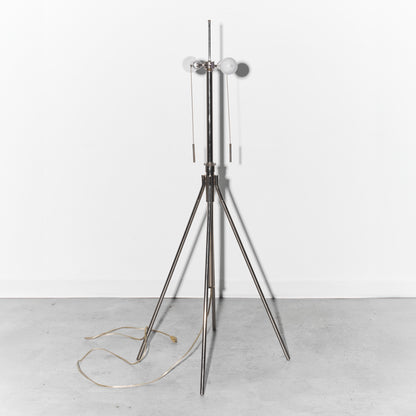 Modern floor lamp with a tripod base on a white background
