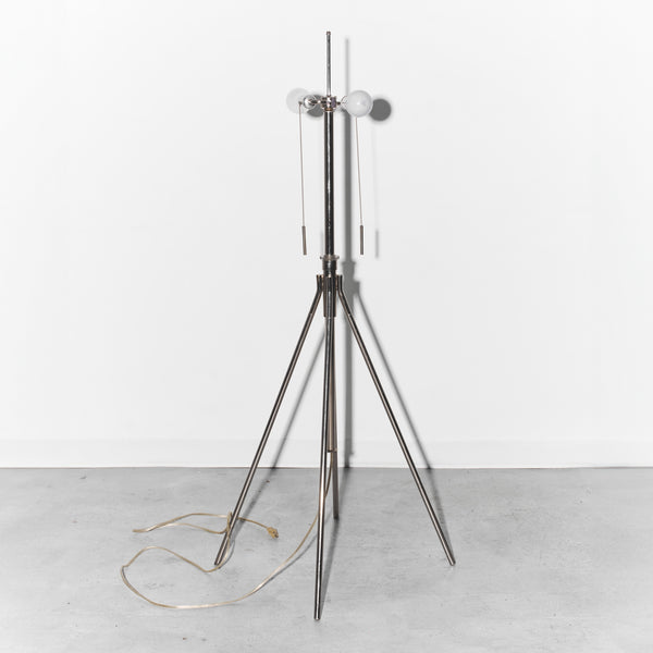 Modern floor lamp with a tripod base on a white background