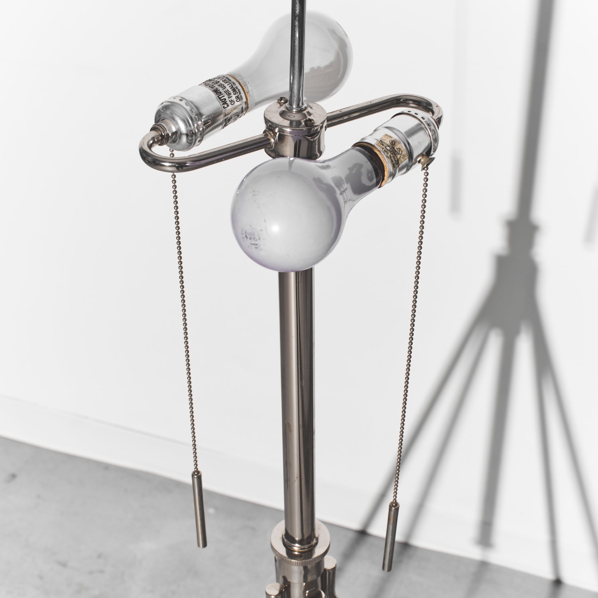 Metallic lamp with hanging light bulbs on a white background