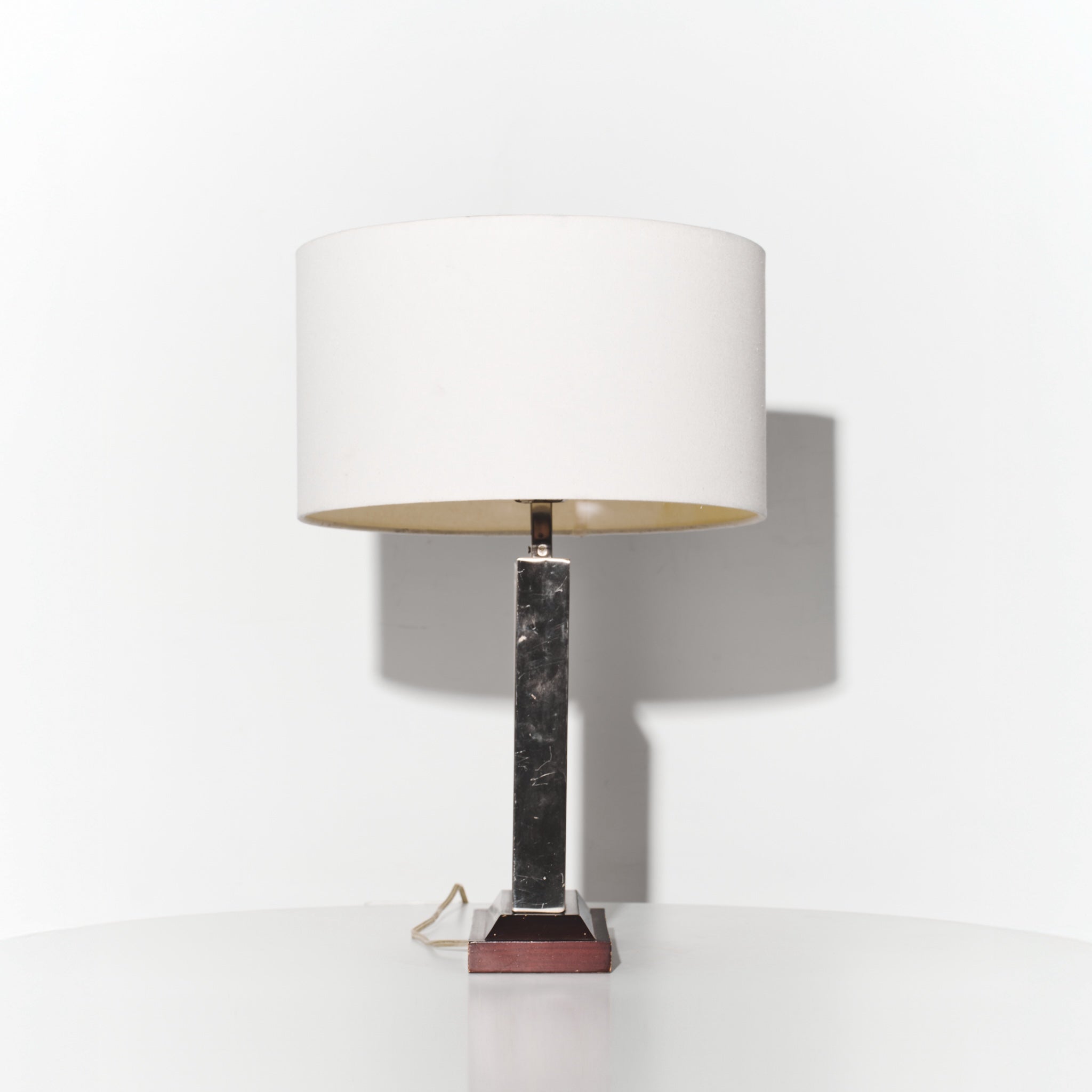 Table lamp with marble base and white shade on a white background