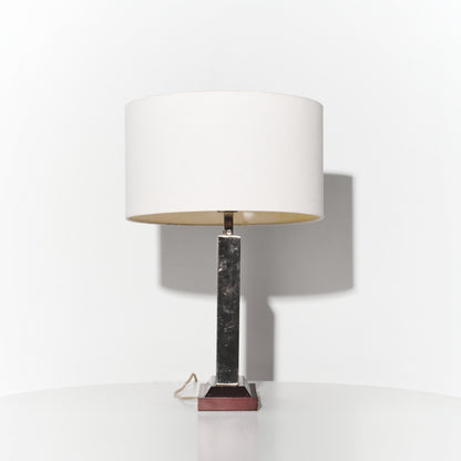 Table lamp with marble base and white shade on a white background