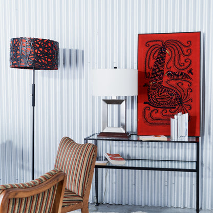 Modern interior with a glass table, wooden chair, and decorative wall art.