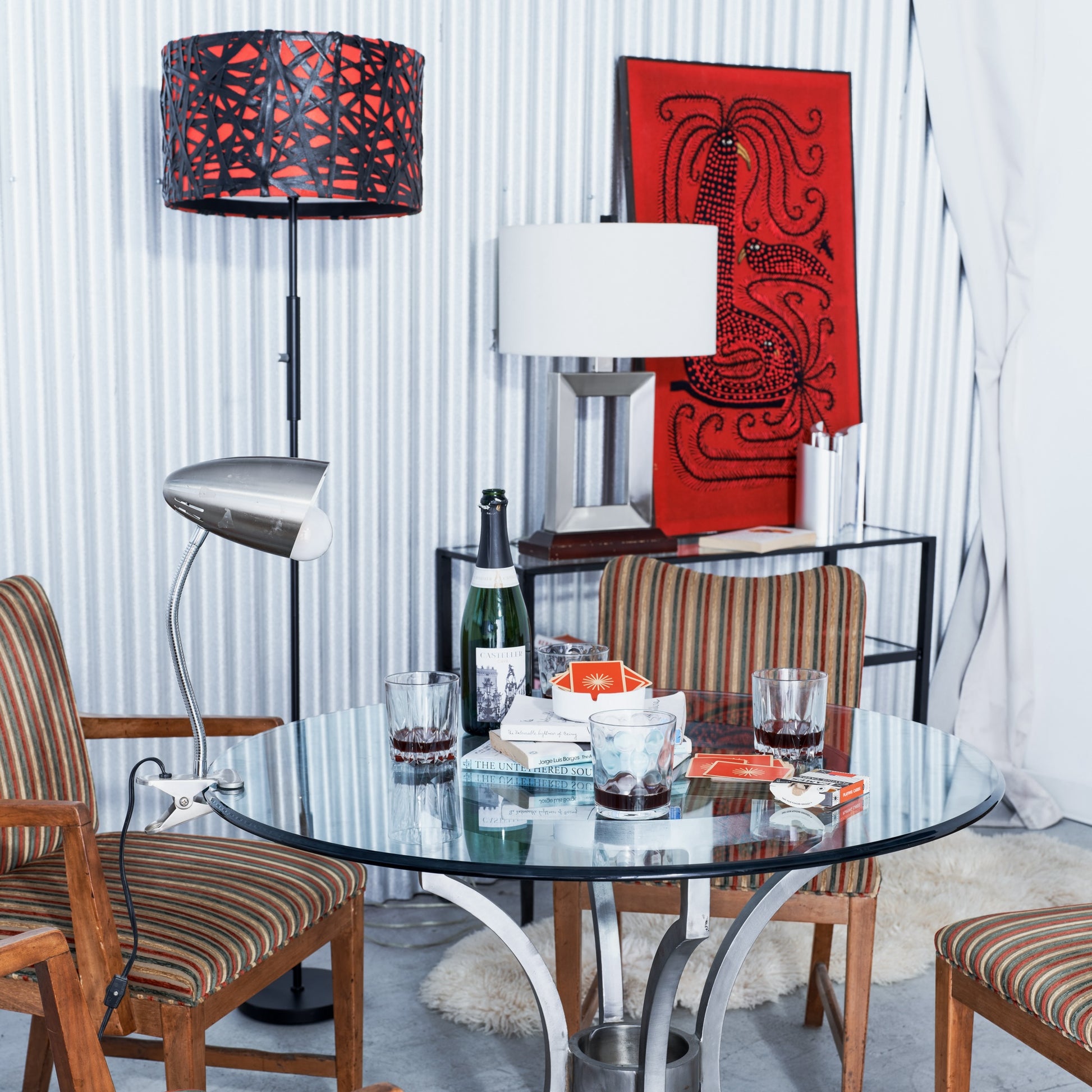 Dining room with a glass table, chairs, and decorative elements.
