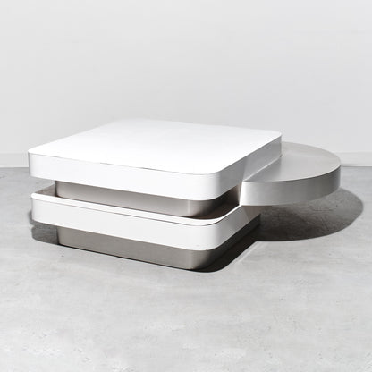 Modern white coffee table on a light gray surface with a neutral background