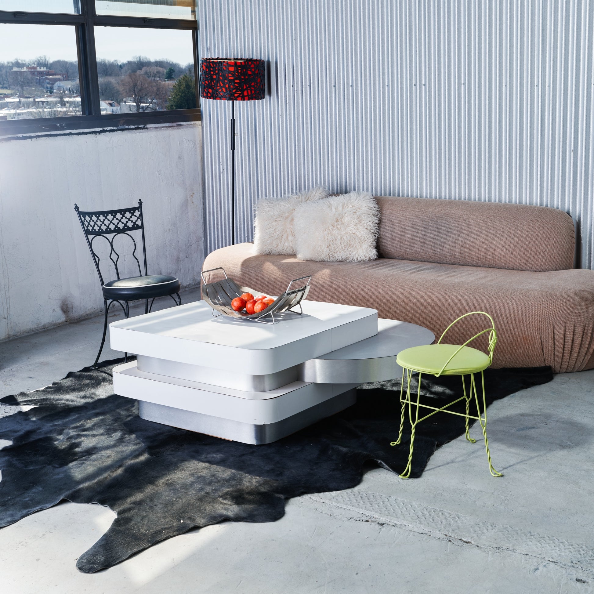 Modern living room with a brown sofa, white coffee table, and decorative items.