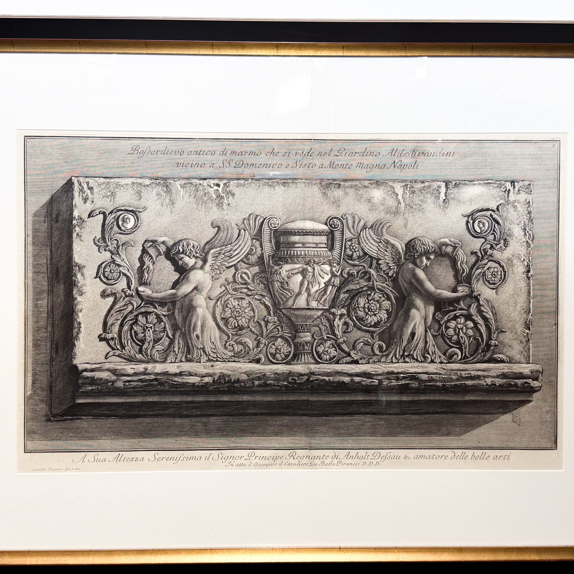 Decorative stone relief with classical design elements on a white background