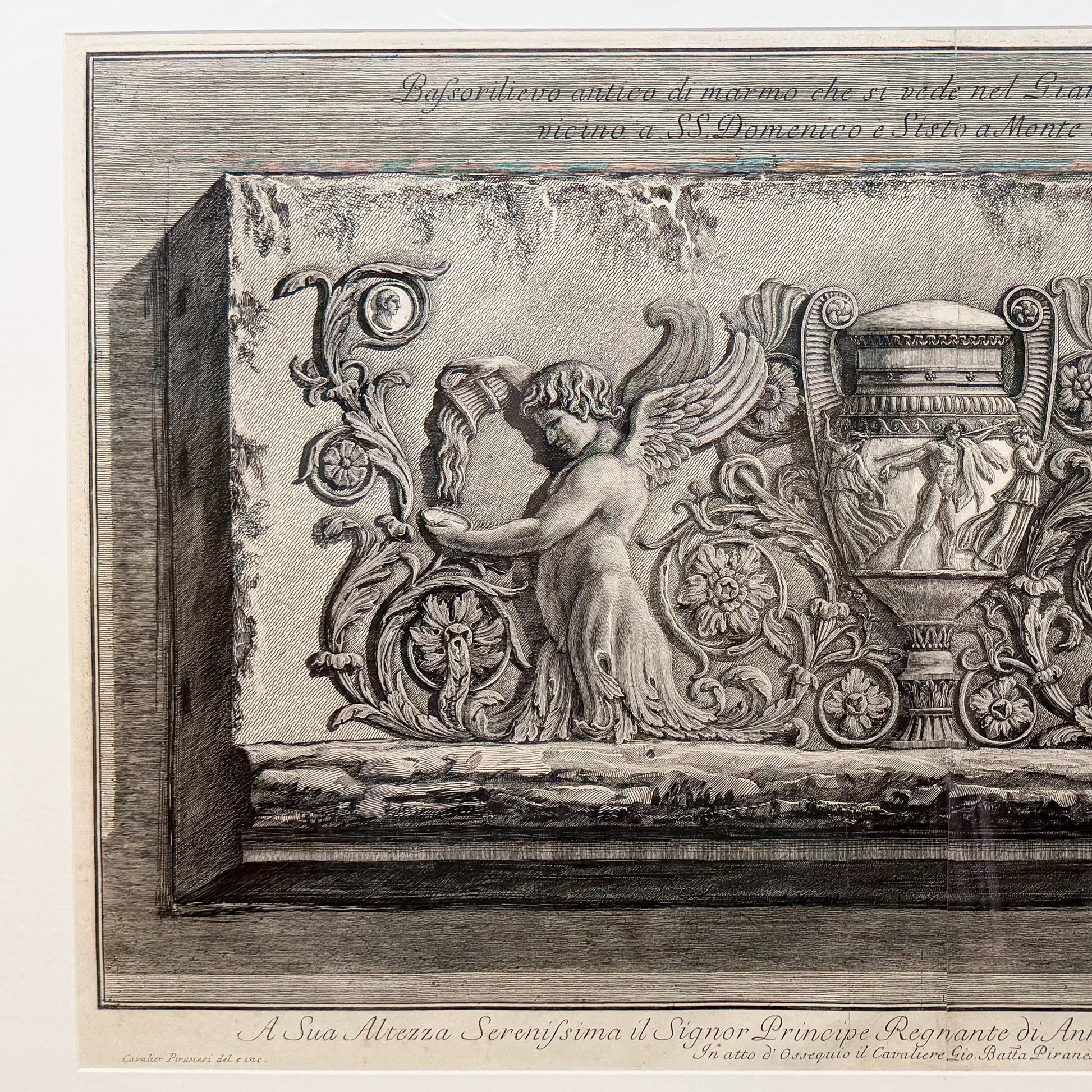 Decorative stone relief with angel and architectural elements, likely from a historical or classical building.