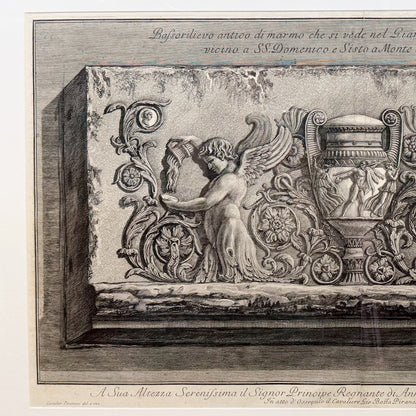 Decorative stone relief with angel and architectural elements, likely from a historical or classical building.