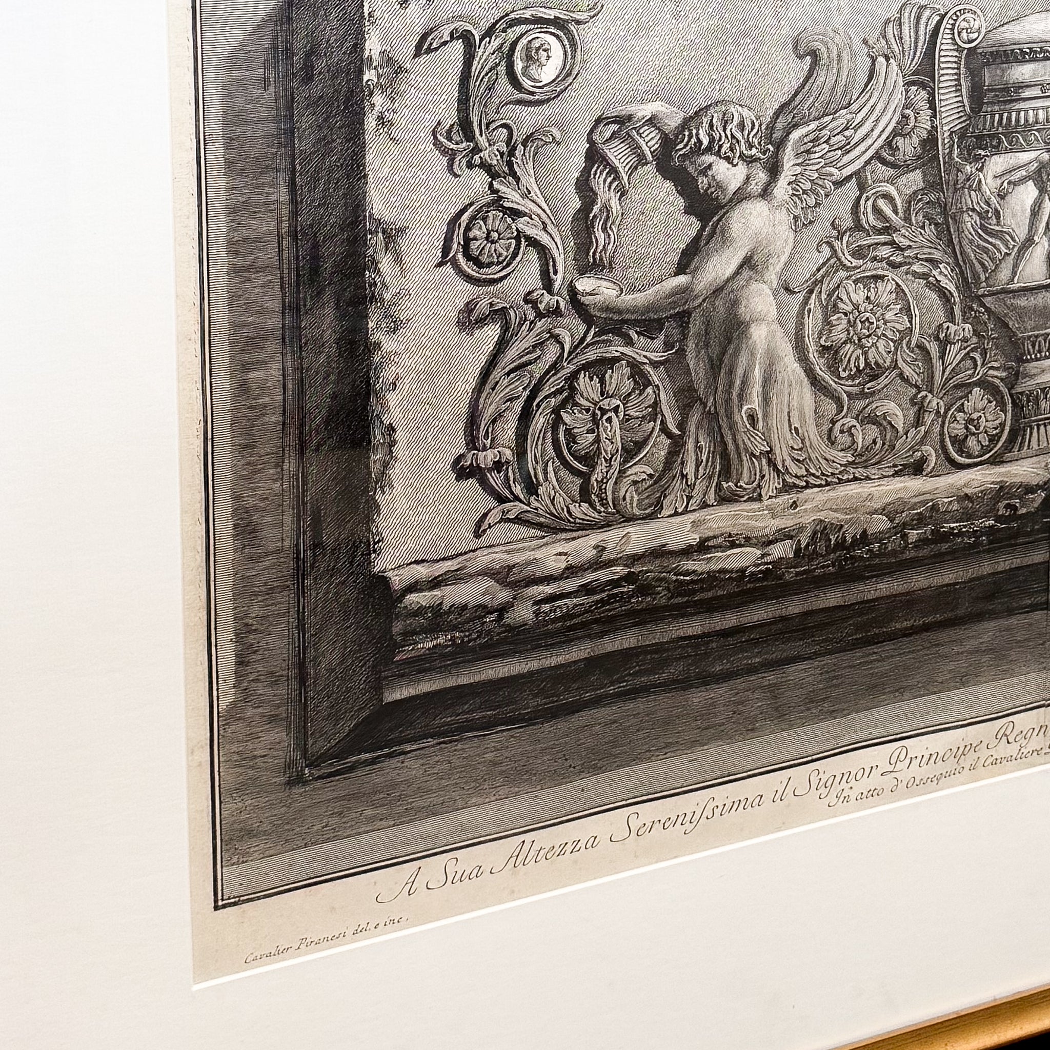 Decorative engraving of an angel with intricate designs on a white background