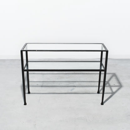 Glass table with black metal frame on a white background