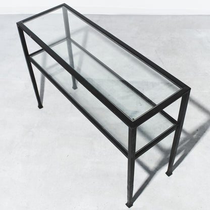 Glass display case with black metal frame on a white background
