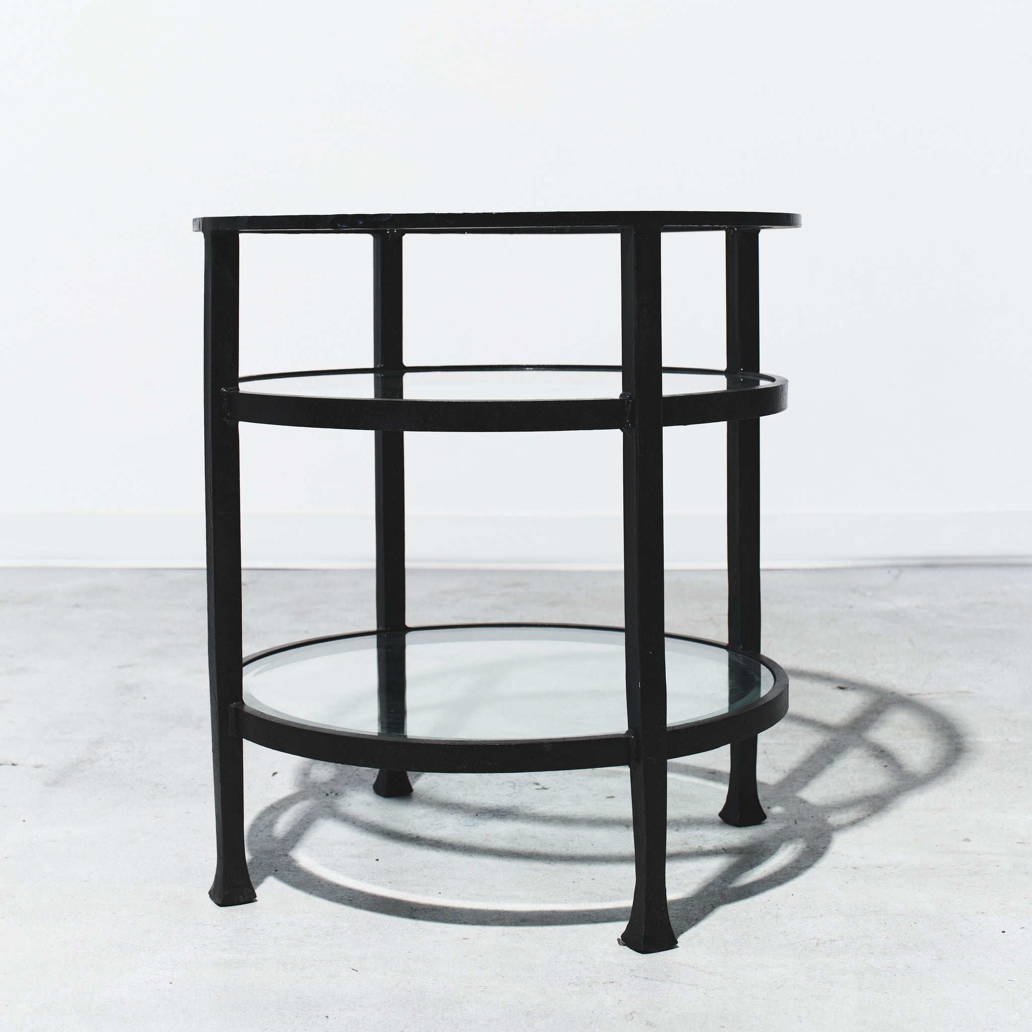 Black metal side table on a white background