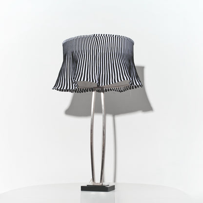 Table lamp with a black and white striped shade on a white background