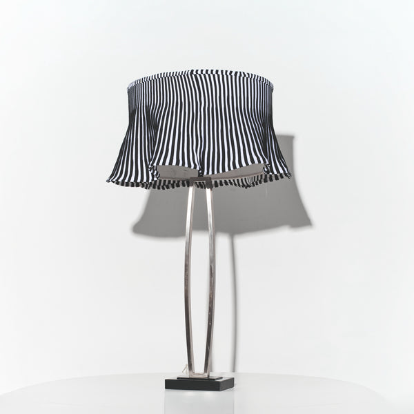 Table lamp with a black and white striped shade on a white background