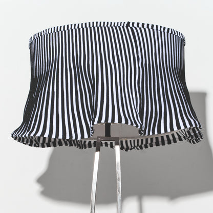 Black and white striped lampshade on a gray background