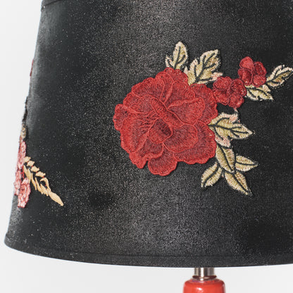 Black lampshade with red floral embroidery on a white background