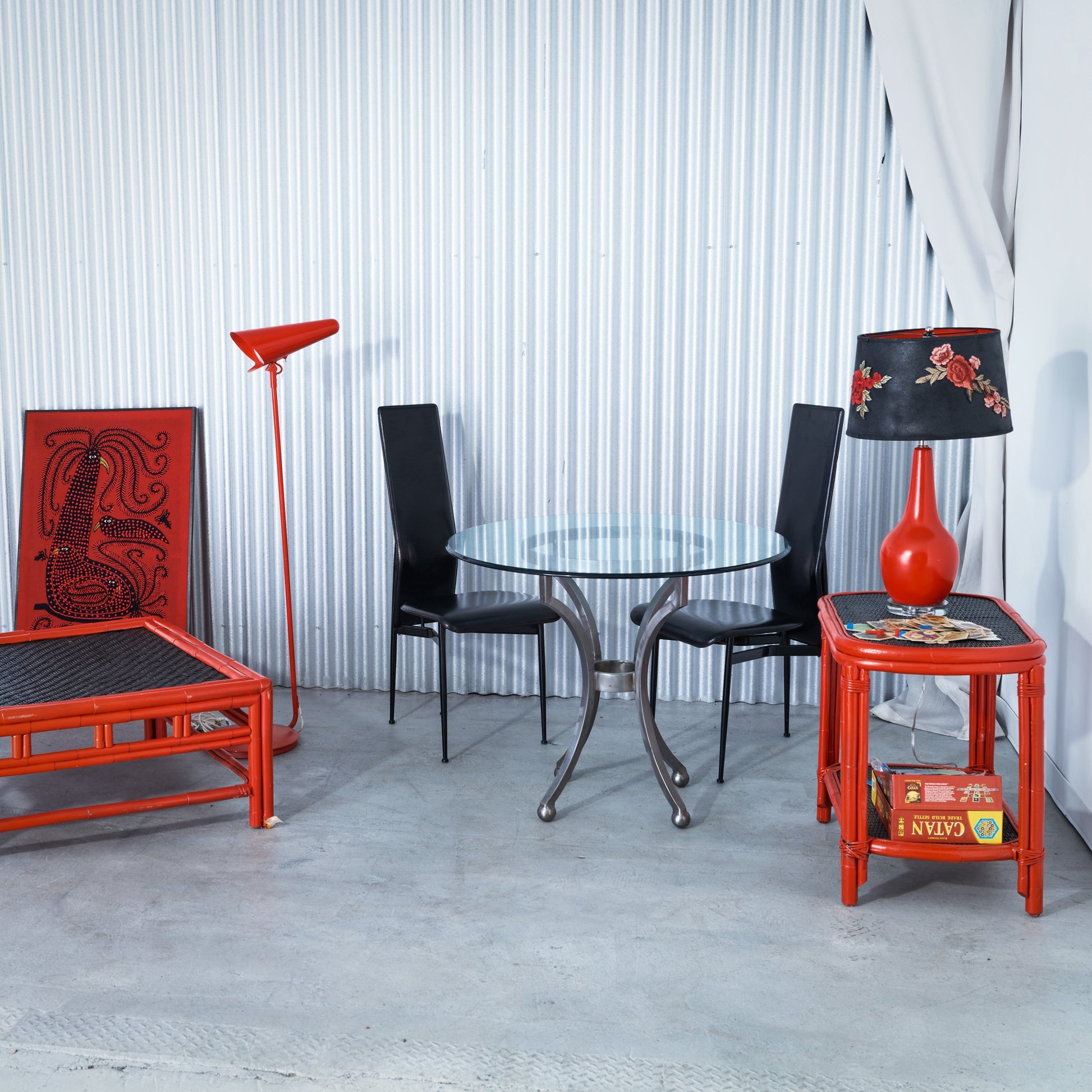Modern interior with red and black furniture against a striped wall.