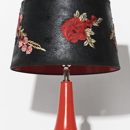 Black lampshade with floral embroidery on a red base