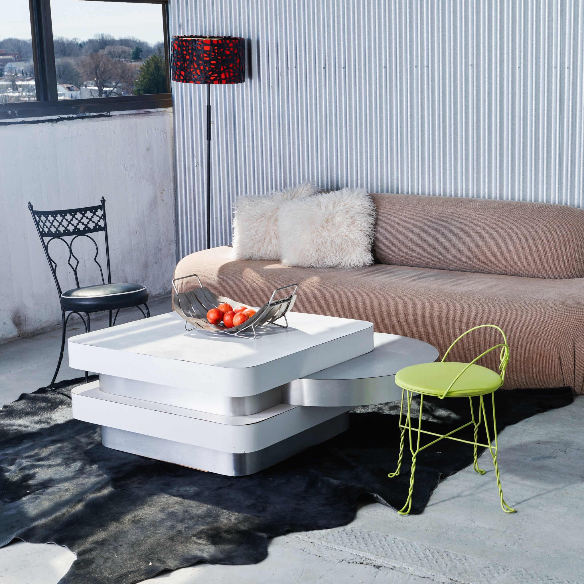 Modern living room with a white coffee table, brown sofa, and decorative lamp.