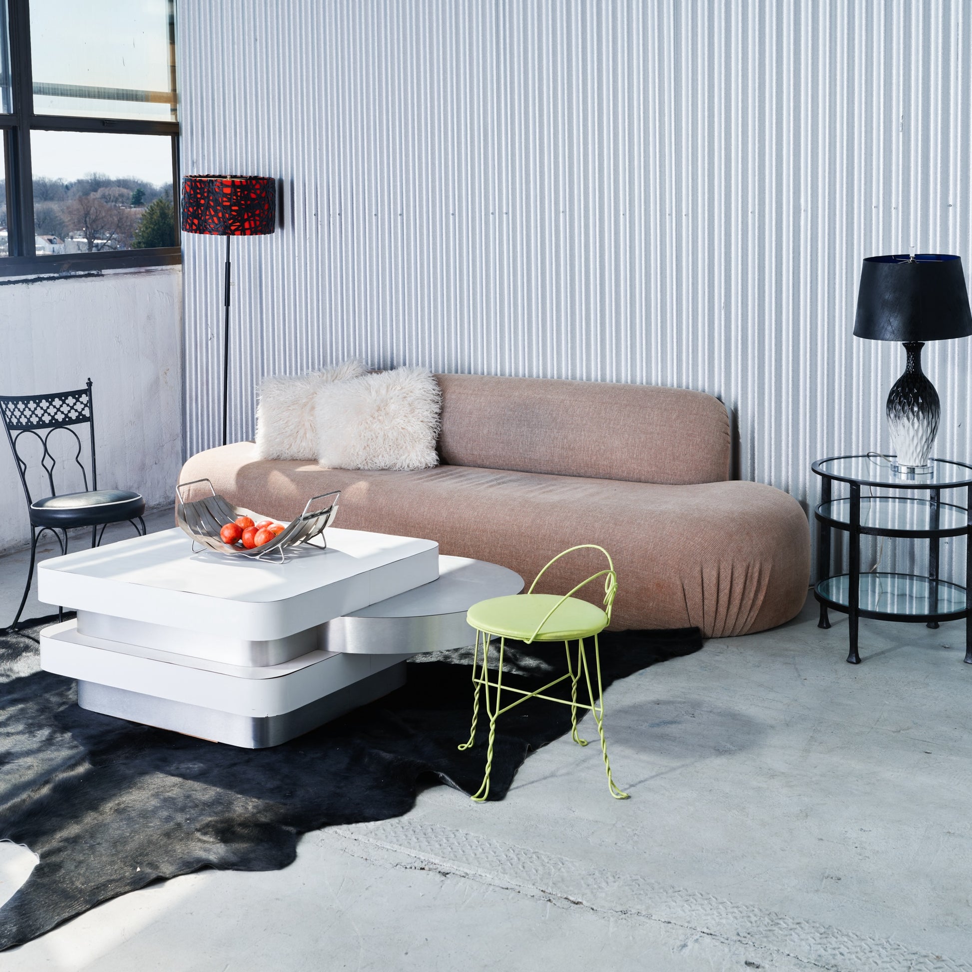 Modern living room with a brown sofa, white coffee table, and a yellow chair.