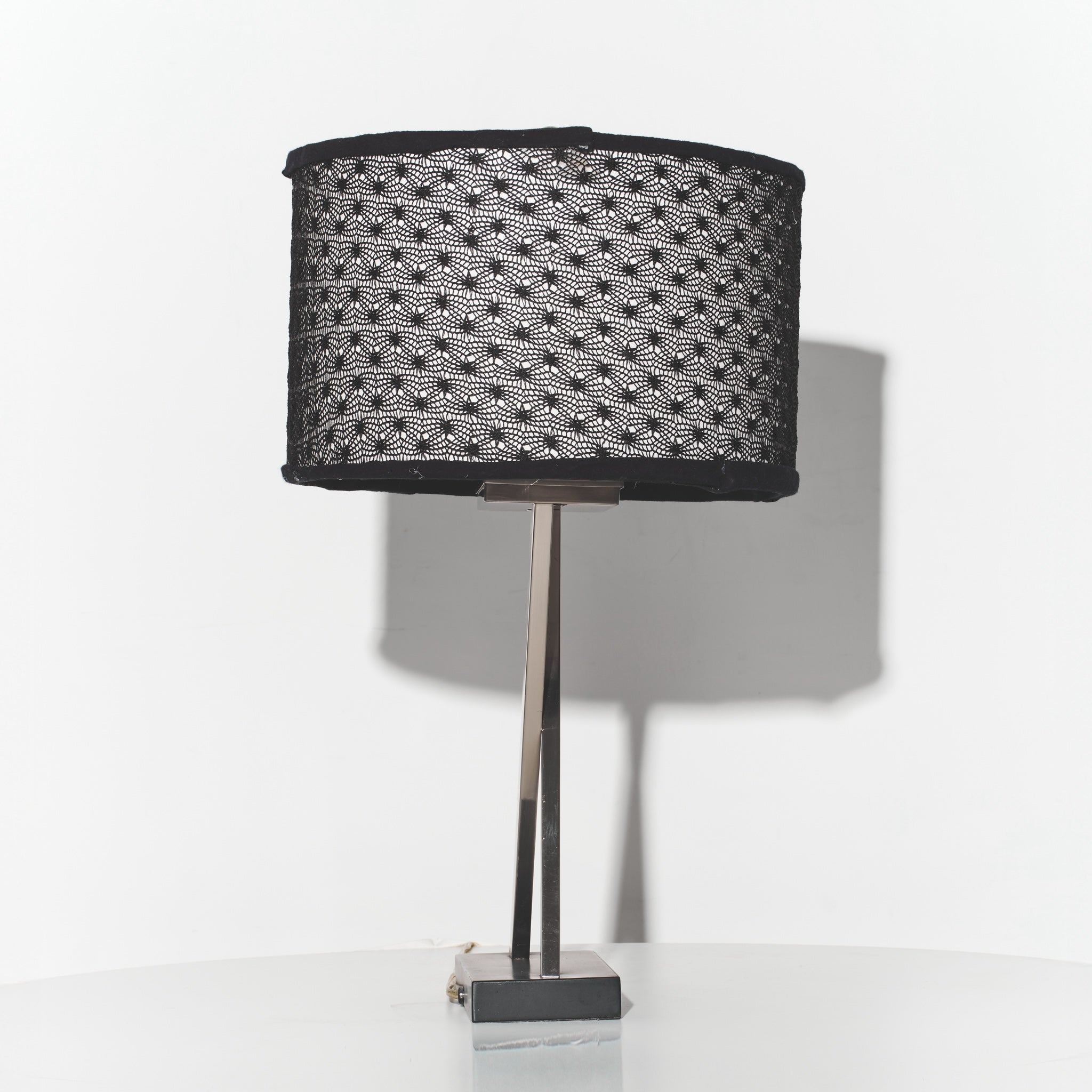 Table lamp with a black textured shade on a white background