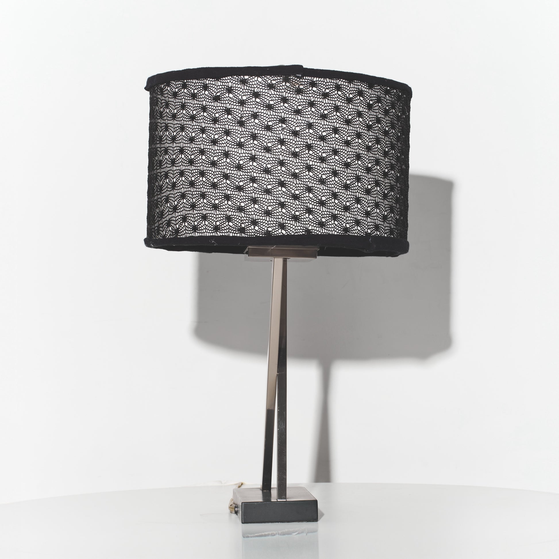 Table lamp with a black textured shade on a white background