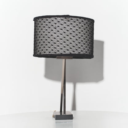 Table lamp with a black textured shade on a white background