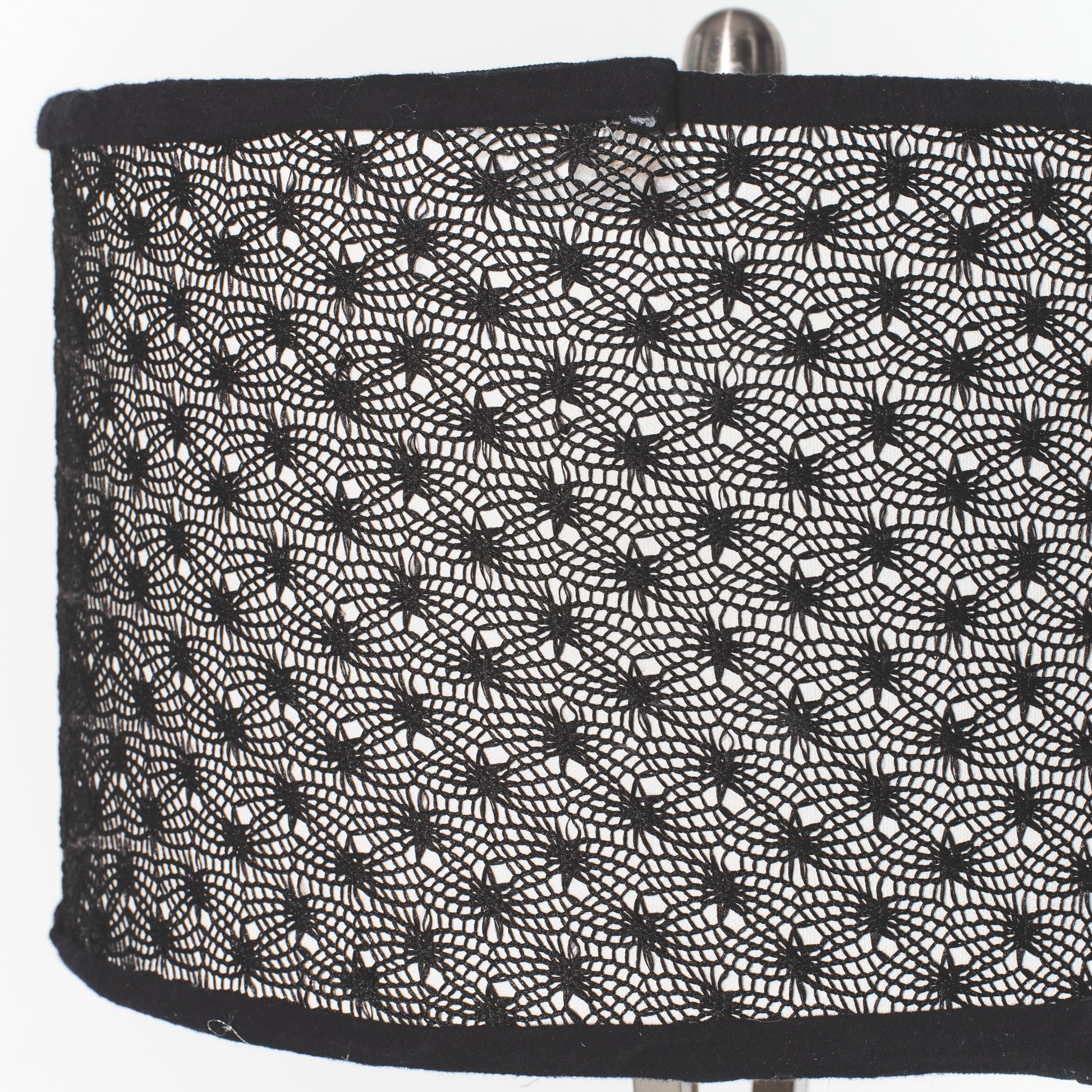 Black spider web pattern on a lampshade