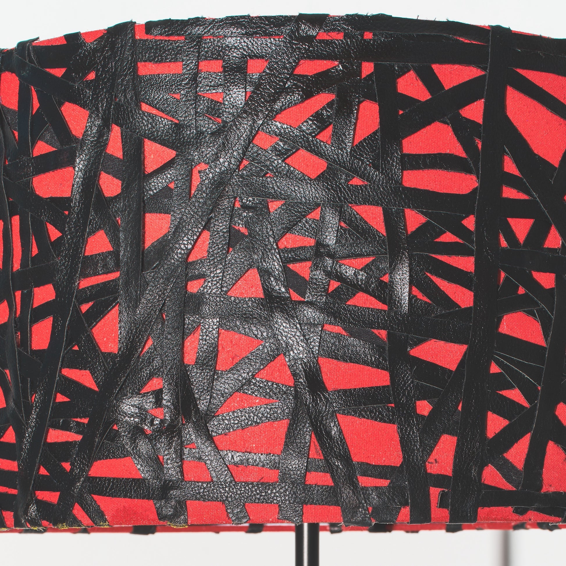 Red and black abstract patterned fabric on a white background