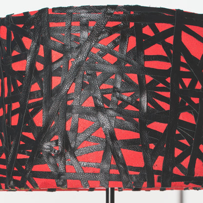Red and black abstract patterned fabric on a white background