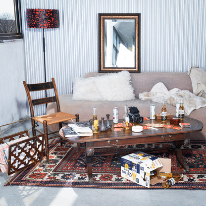 Living room with a coffee table, couch, and decorative items.