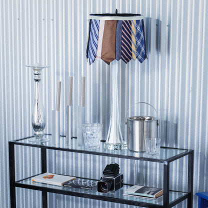 Glass table with decorative items against a corrugated metal wall