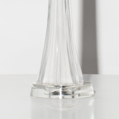 Clear glass Lamp base on a white surface with a neutral background