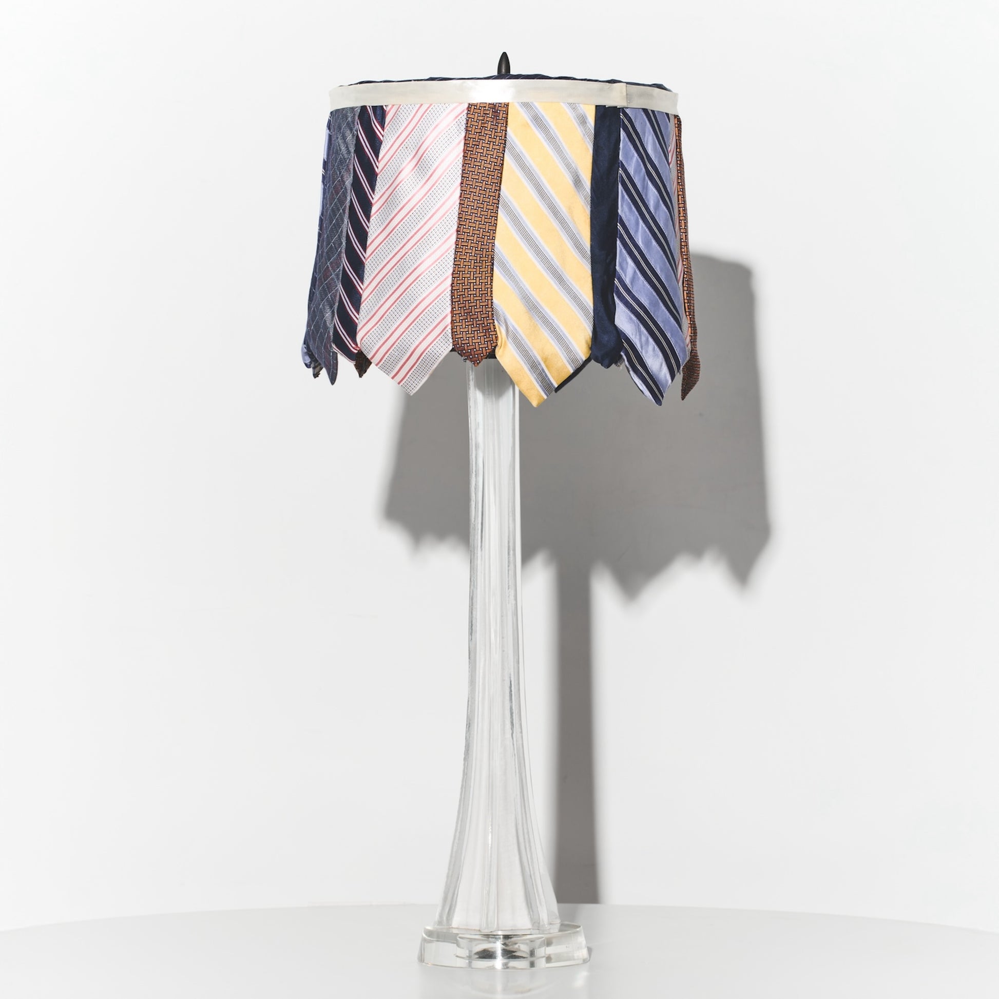 Lamp with a colorful striped shade on a white background