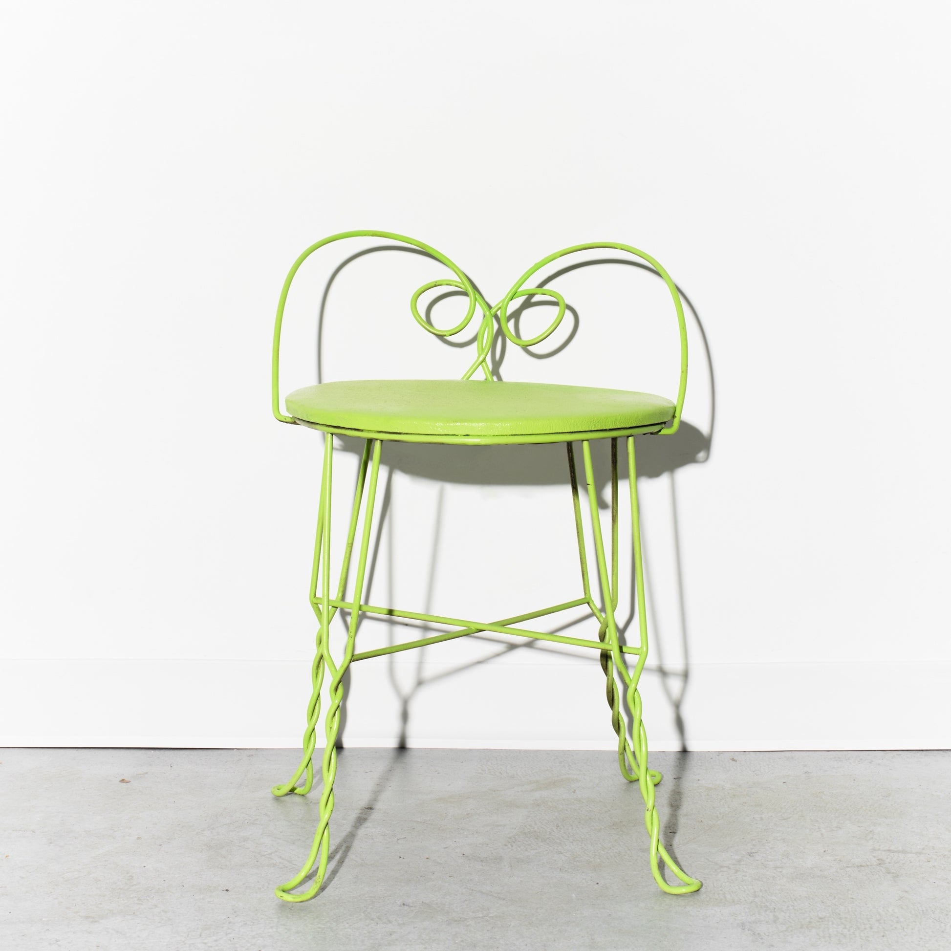 Green metal chair on a white background