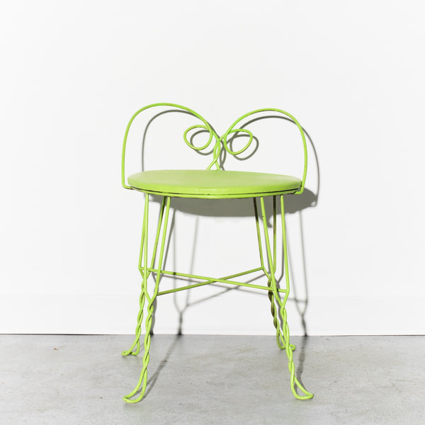 Green metal chair on a white background